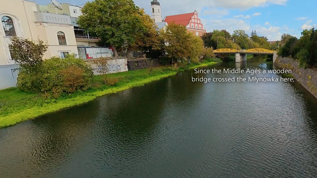 Frame from a 360° film with its caption (Opole): “Since the Middle Ages a wooden bridge crossed the Młynówka here;”